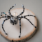 artisan-crafted beaded spider with black seed beads, iridescent accents, and ornate metallic body, perfect for home décor or gifting.